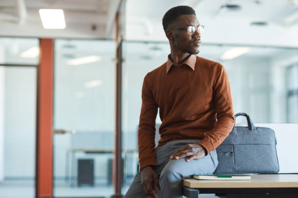 istock Contemporary African-American Man Looking Away in Office 1255016651