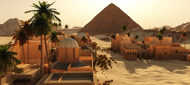 Arabic small town on desert beside pyramid