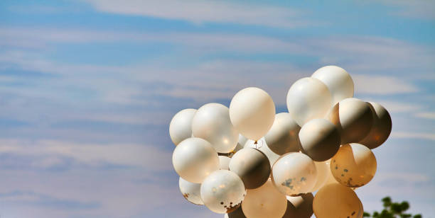 istock White balloons, outdoor at a celebration, short before getting started on blue sky 1255020211