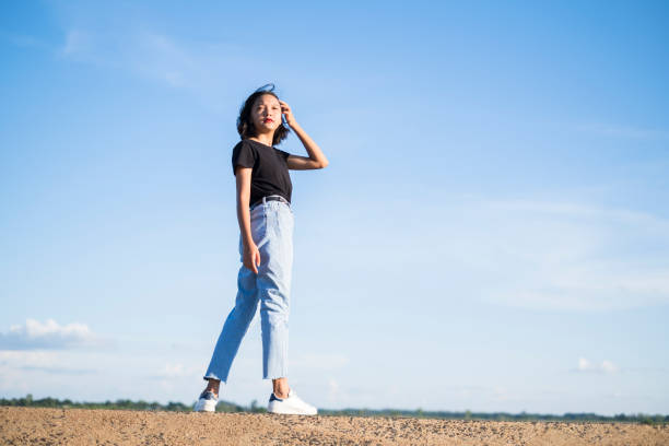istock Happy young asian girl with blue sky. 1255020468