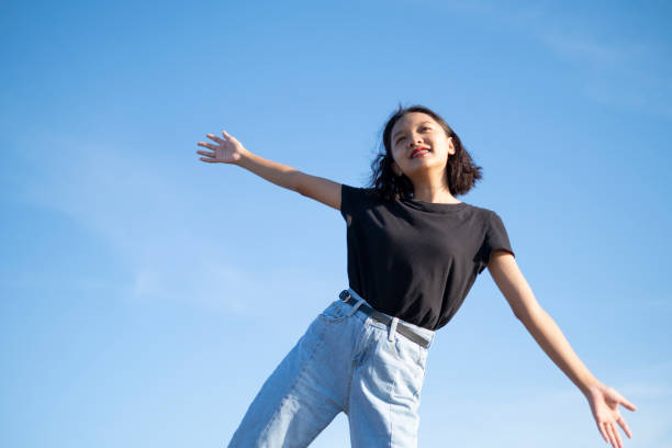 istock Happy young asian girl with blue sky. 1255020509