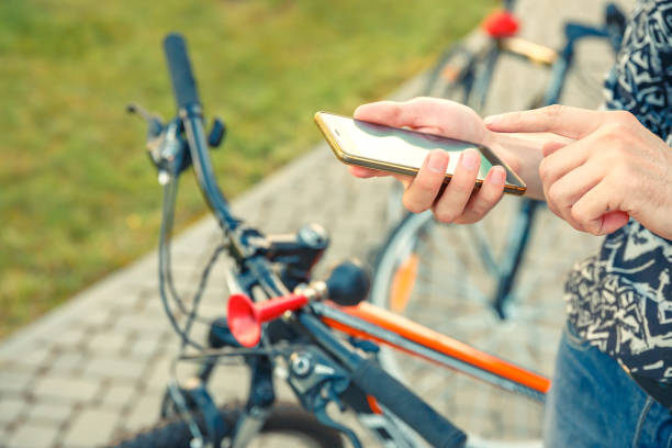istock Hiker cyclist is looking for a road on a smartphone. 1255020581