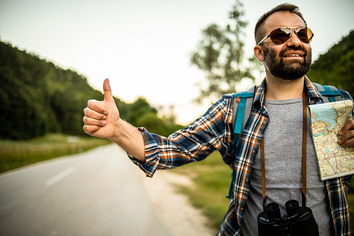 Hitchhiking with thumb up - Adventurer uses alternative transport - Sloboda - Hitchhiking and sightseeing