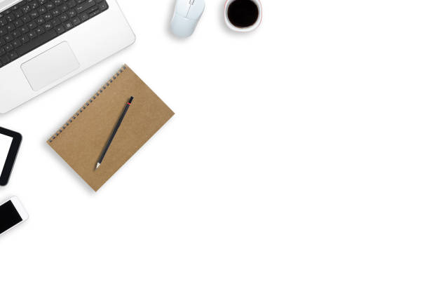istock top view white table office working. workplace desk overhead design flat lay with laptop keyboard, coffee cup, mouse, smartphone, tablet and stationery accessories supply. 1255024373