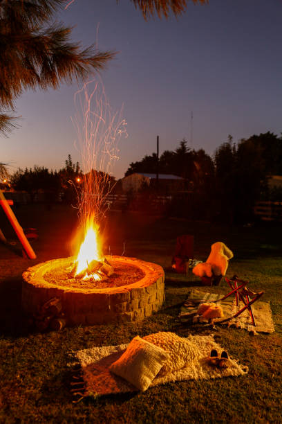 istock Rustic campfire and chairs around in the garden at night 1255027531