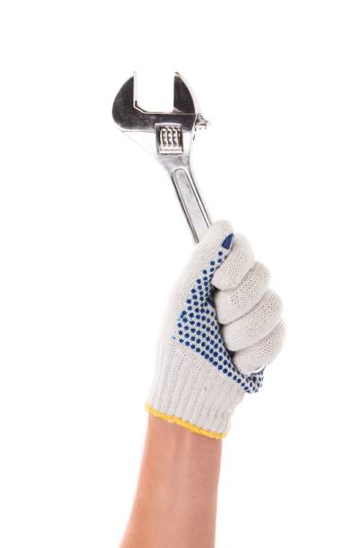 istock A gloved hand holds an adjustable wrench. 1255028018
