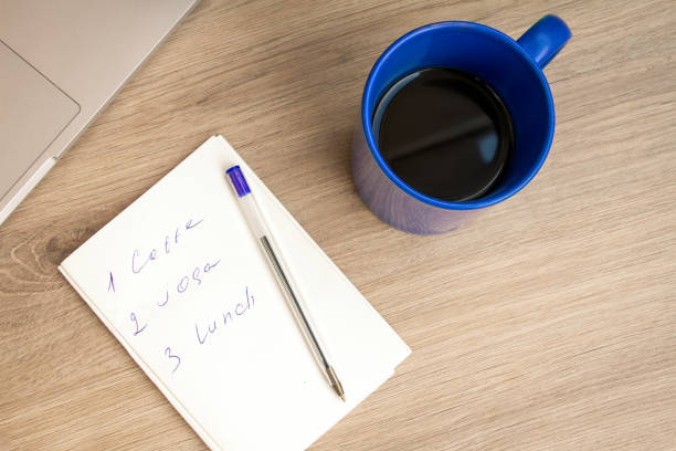 istock Good morning with coffee. A cup of coffee in blue. Notepad with daily routine. 1255028234