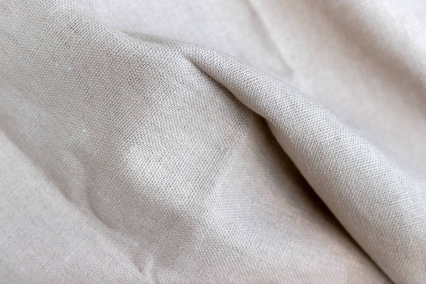 istock Natural linen fabric texture. Rough crumpled burlap background. Selective focus. Closeup view 1255030095