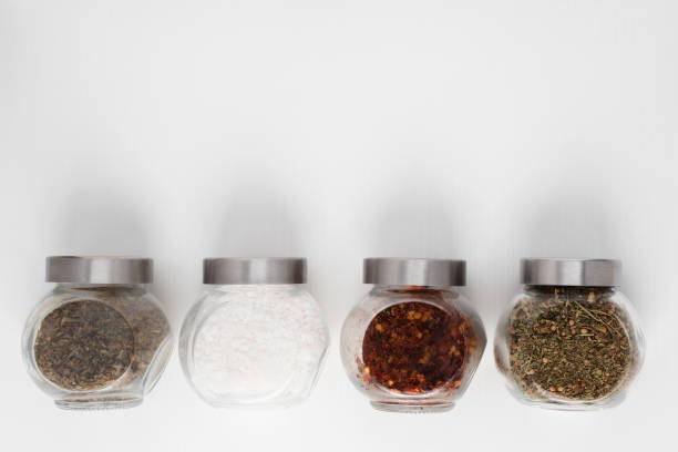 istock Set of spices on the table with copy space. Different herbs - Oregano, basil, rosemary, thyme, caraway seeds, tarragon, savory, coriander, marjoram, oregano, fennel, pepper, garlic, sage, sea salt, hot pepper 1255030739