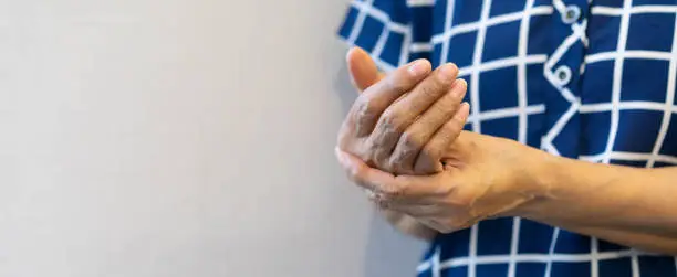 Photo of close up mature senior woman massage on hand to relief pain from hard working for treatment about carpal tunnel syndrome and chronic illness health care concept