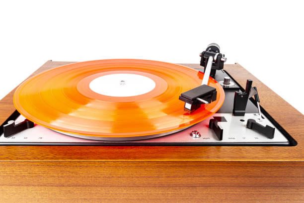 istock Vintage turntable with a red vinyl isolated on white 1255032621