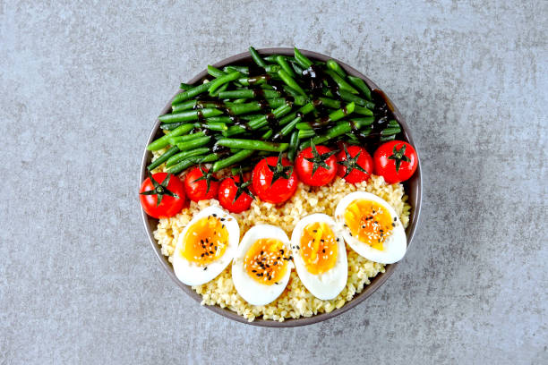 istock Buddha bowl with bulgur, green beans, cherry tomatoes and boiled egg halves. 1255032878