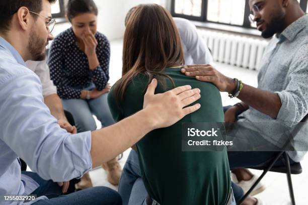 During Group Therapy Session Members Supporting Crying Desperate Girl Stock Photo - Download Image Now
