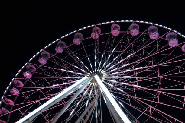 istock luminous ferris wheel against the night sky. 1255033050