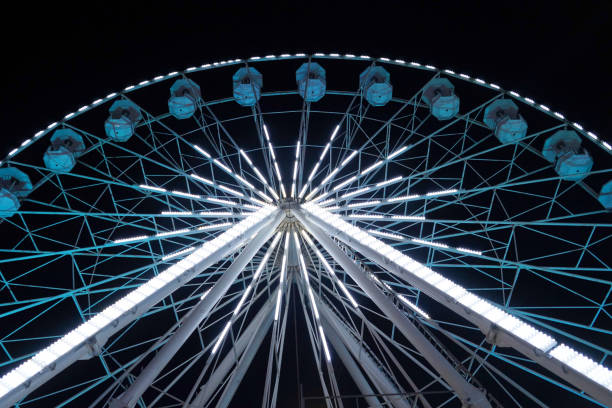 istock luminous ferris wheel against the night sky. 1255033065