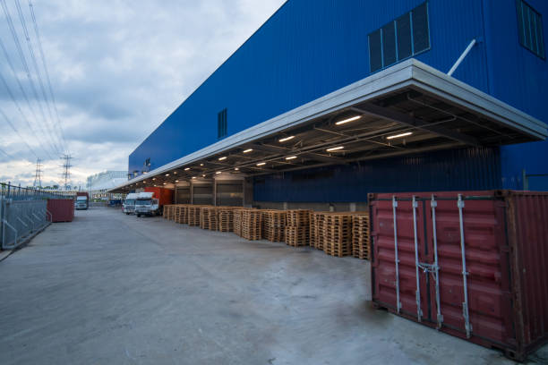 istock Truck is carrying container parking in front warehouse 1255035598