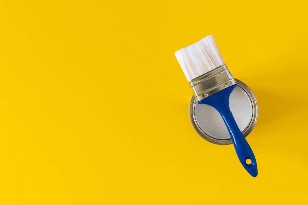 istock Can of white paint with a brush 1255035719