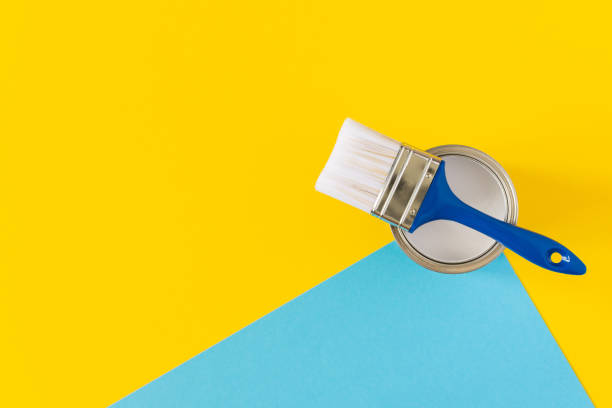 istock Can of white paint with a brush 1255035721