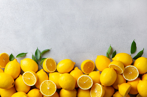 Fresh lemons on grey background. Copy space. Top view.