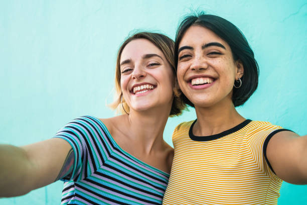 istock Lovely lesbian couple taking a selfie. 1255036876