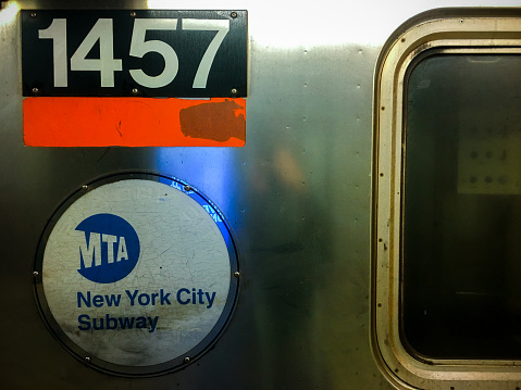 New York, USA - 03 27 2018: New York city subway train approaching subway station