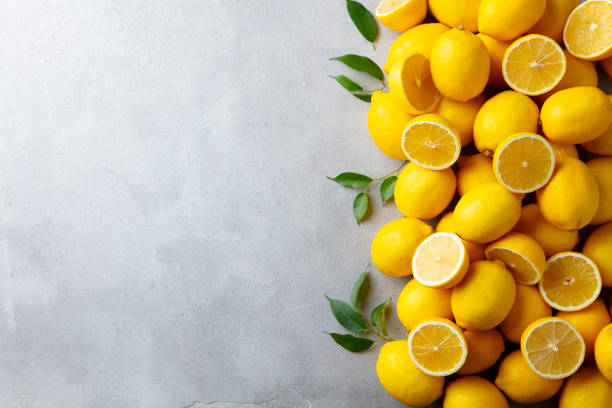istock Fresh lemons on grey background. Copy space. Top view. 1255040223