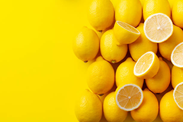 Fresh lemons on yellow background. Copy space. Top view. Fresh lemons on yellow background. Copy space. Top view. halved photos stock pictures, royalty-free photos & images