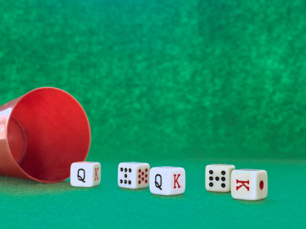 istock Poker dice game on a green tablecloth 1255040336