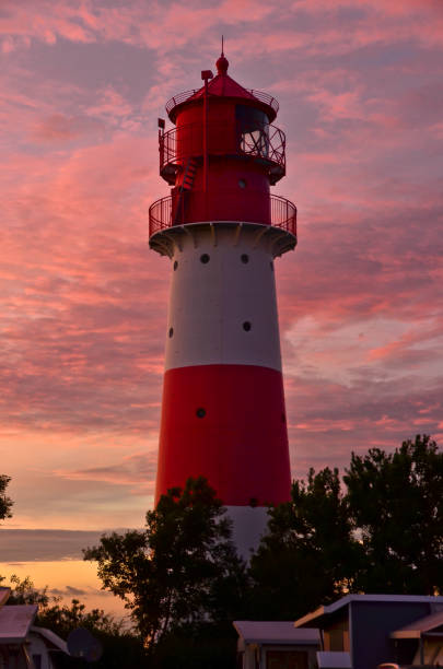 istock A small and beautiful lighthouse in the evening dawn sunset with pink clouds and bright light in Falshöft, Germany 1255041787