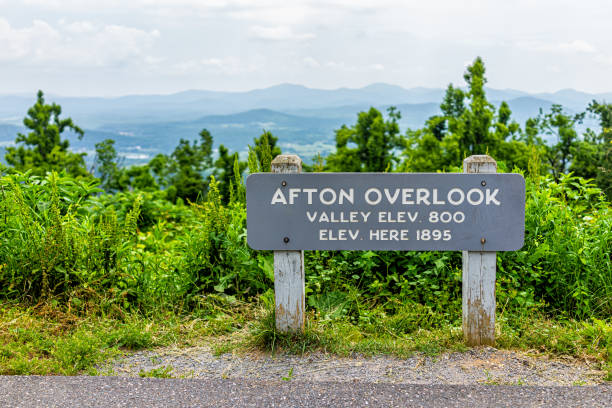 Overlook sign for Afton valley and elevation at Blue Ridge parkway appalachian mountains in summer with nobody and scenic lush foliage Overlook sign for Afton valley and elevation at Blue Ridge parkway appalachian mountains in summer with nobody and scenic lush foliage skyline drive virginia photos stock pictures, royalty-free photos & images