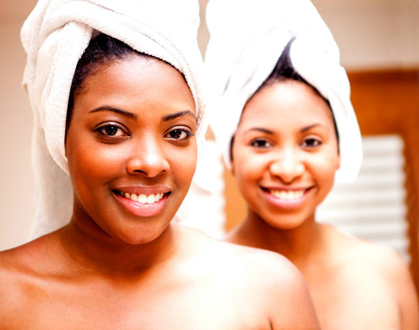 istock Happy black women at the spa pampering while smiling at camera 1255048840