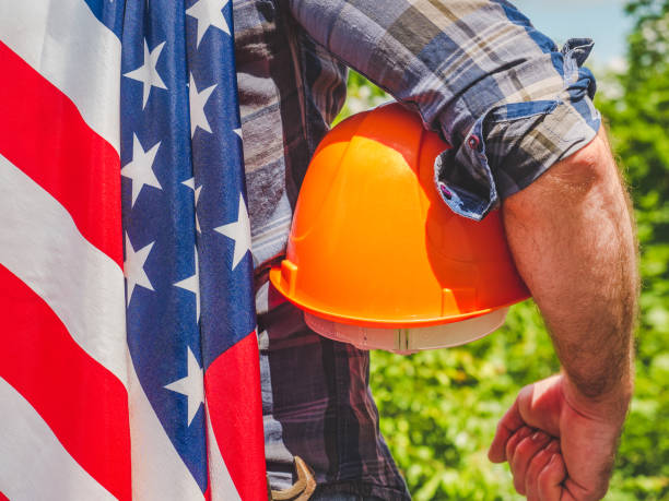 istock Handsome man with tools, holding an American Flag 1255050832