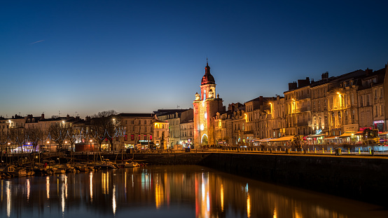 Panoramic view of the grosse horloge of La Rochelle at blue hour with beautiful illuminated city lights