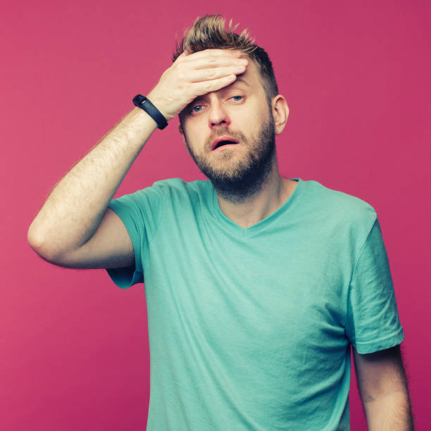 istock studio picture from a young man suffering from a headache due to a cold or hangover 1255054961