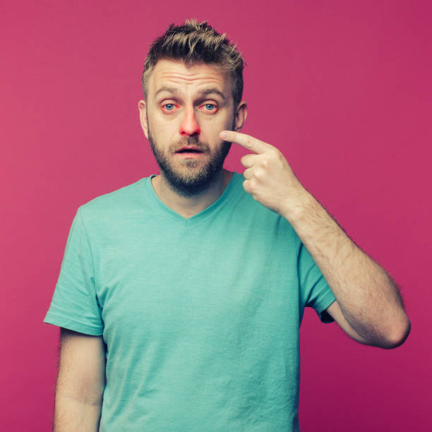 istock Sick guy isolated has runny nose. man makes a cure for the common cold 1255055081