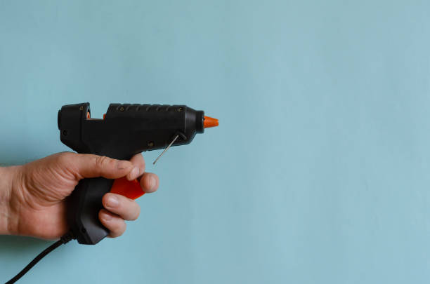 istock Glue thermo gun in a male hand. 1255056517