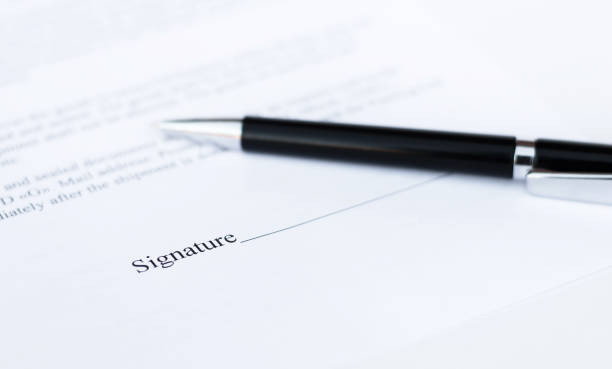 istock pen on a sheet of paper close-up on a white background. Contracts, business 1255056708