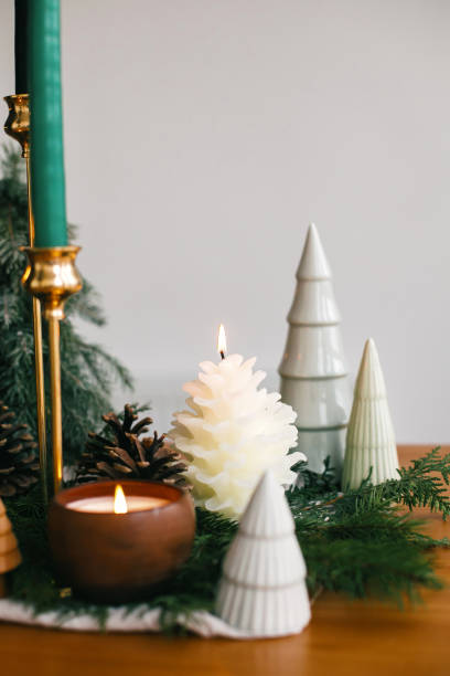 istock Christmas trees, candles and pine cones on rustic fabric on wooden table. Festive modern decor, zero waste. Miniature wooden and handmade pine trees.  Happy holidays 1255058461