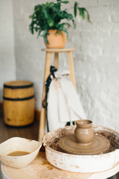 istock Pottery studio. Potter's wheel and tools for working with clay. Ceramics production. 1255059590