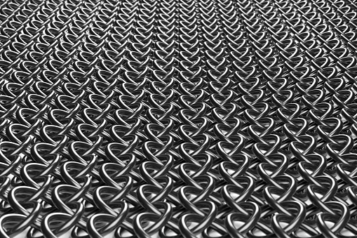 Texture of chain mail from metal rings close-up.