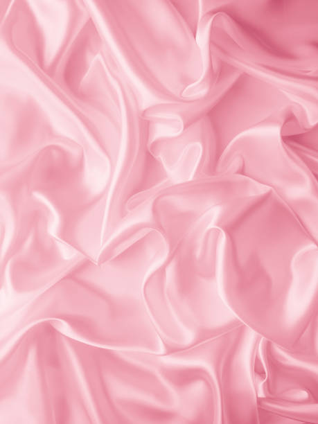 istock Beautiful elegant wavy light pink satin silk luxury cloth fabric texture. 1255061616