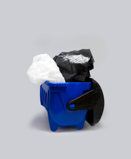 istock Blue toy mini trash garbage can bin container with plastic bags rubbish at isolated background 1255062238