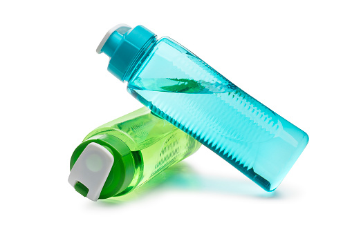 Blue Water Bottle Leaning on a Green Water Bottle isolated on a white background