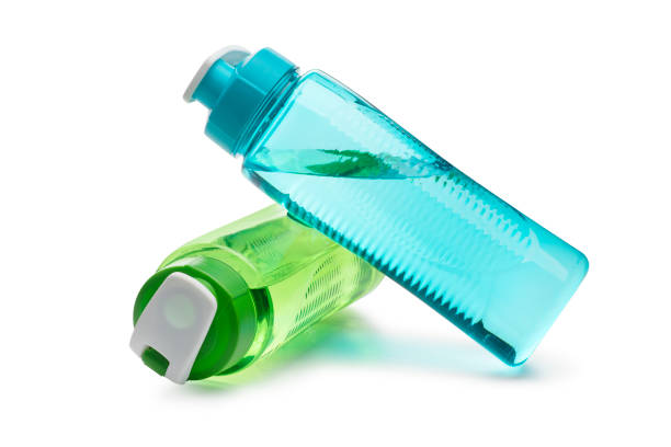 Blue and Green Water Bottle Leaning on Each other isolated on a white background Blue Water Bottle Leaning on a Green Water Bottle isolated on a white background blue reusable water bottle stock pictures, royalty-free photos & images