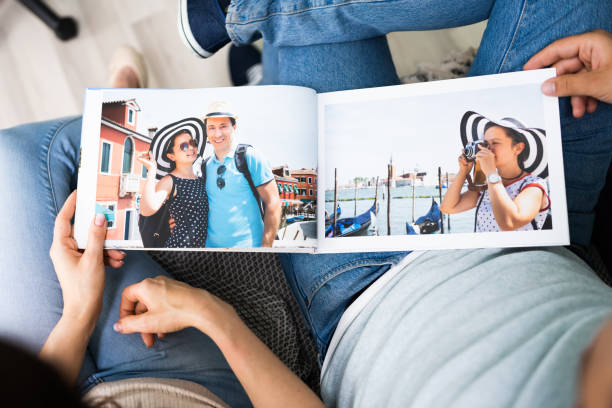 Couple Family Looking Photo Album Couple Family Looking Photo Album Or Photobook family photos album stock pictures, royalty-free photos & images