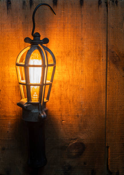 istock Lighted Antique Work Light on Wooden Crate 1255067936