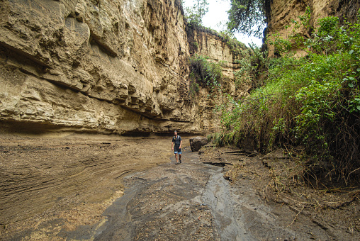 Man walking in a Canyon in Hell’s Gate National Park Lake Naivasha Kenya