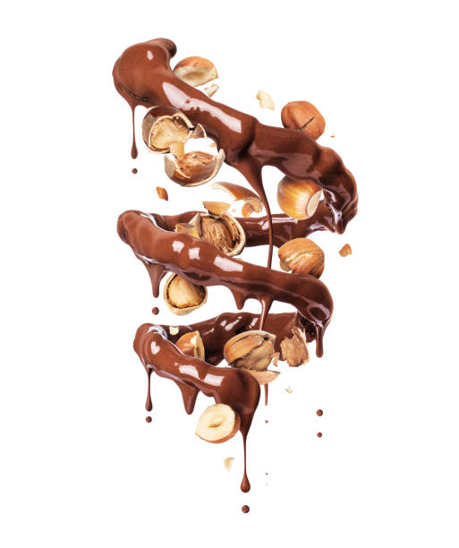 istock Chocolate splashes in spiral shape with crushed hazelnuts on a white background 1255071238
