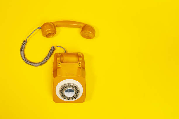 istock Old fashioned handset on yellow color background. Modern retro style. 1255071637