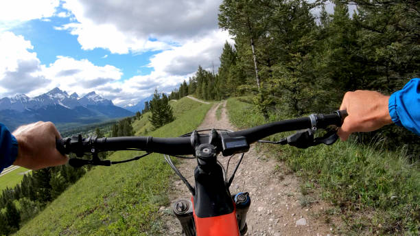 istock Mountain e-biker rides along mountain trail 1255072578